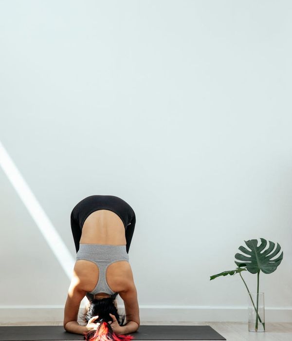 Woman in a calm yoga pose in a bright, modern studio.